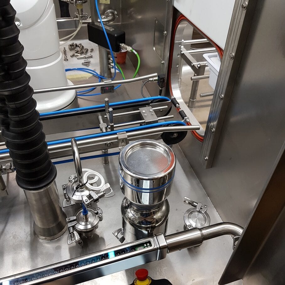 FS100 with wash head mounted in isolator for automatic cleaning